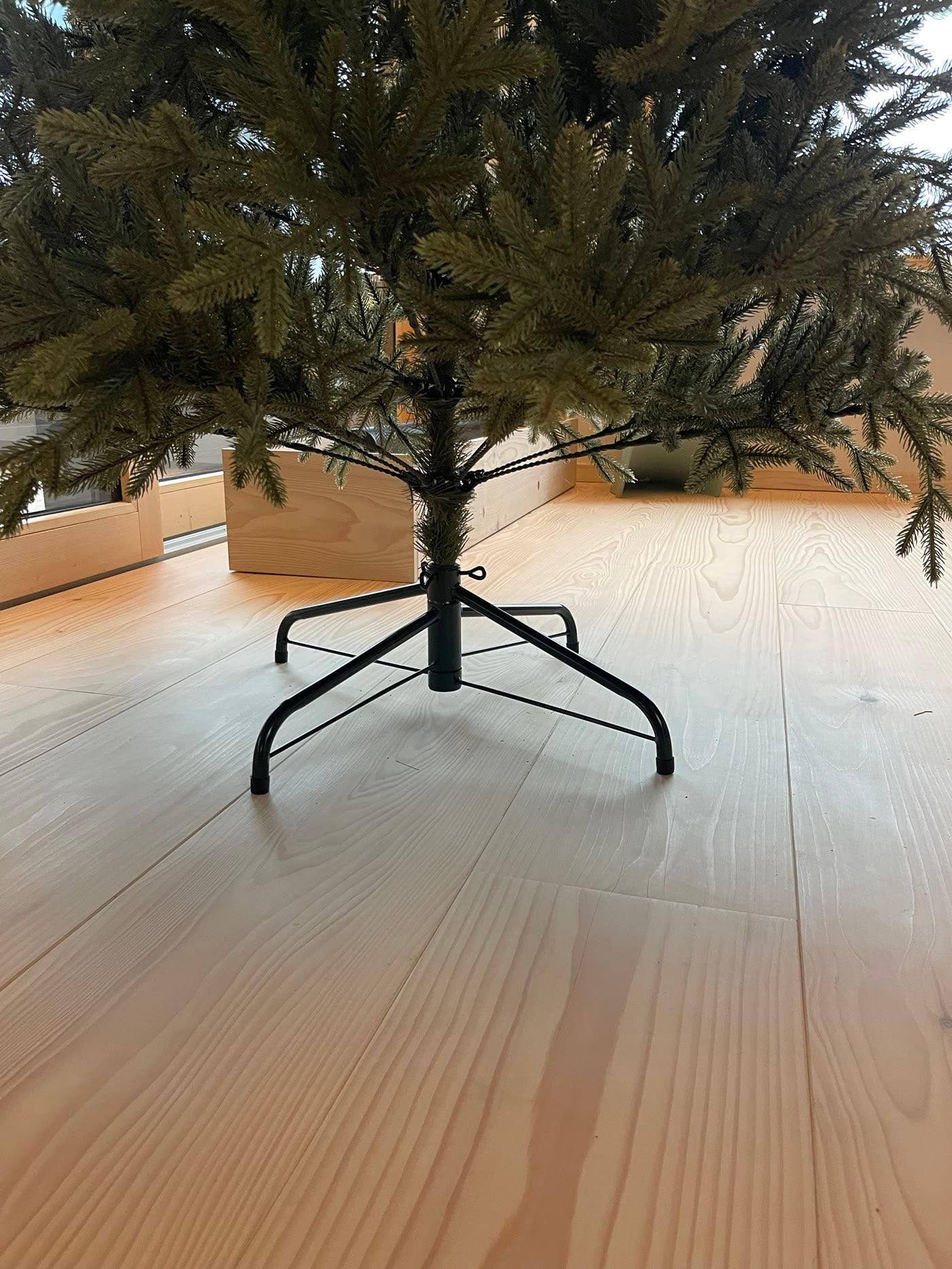 The metal stand, unfolded on the floor